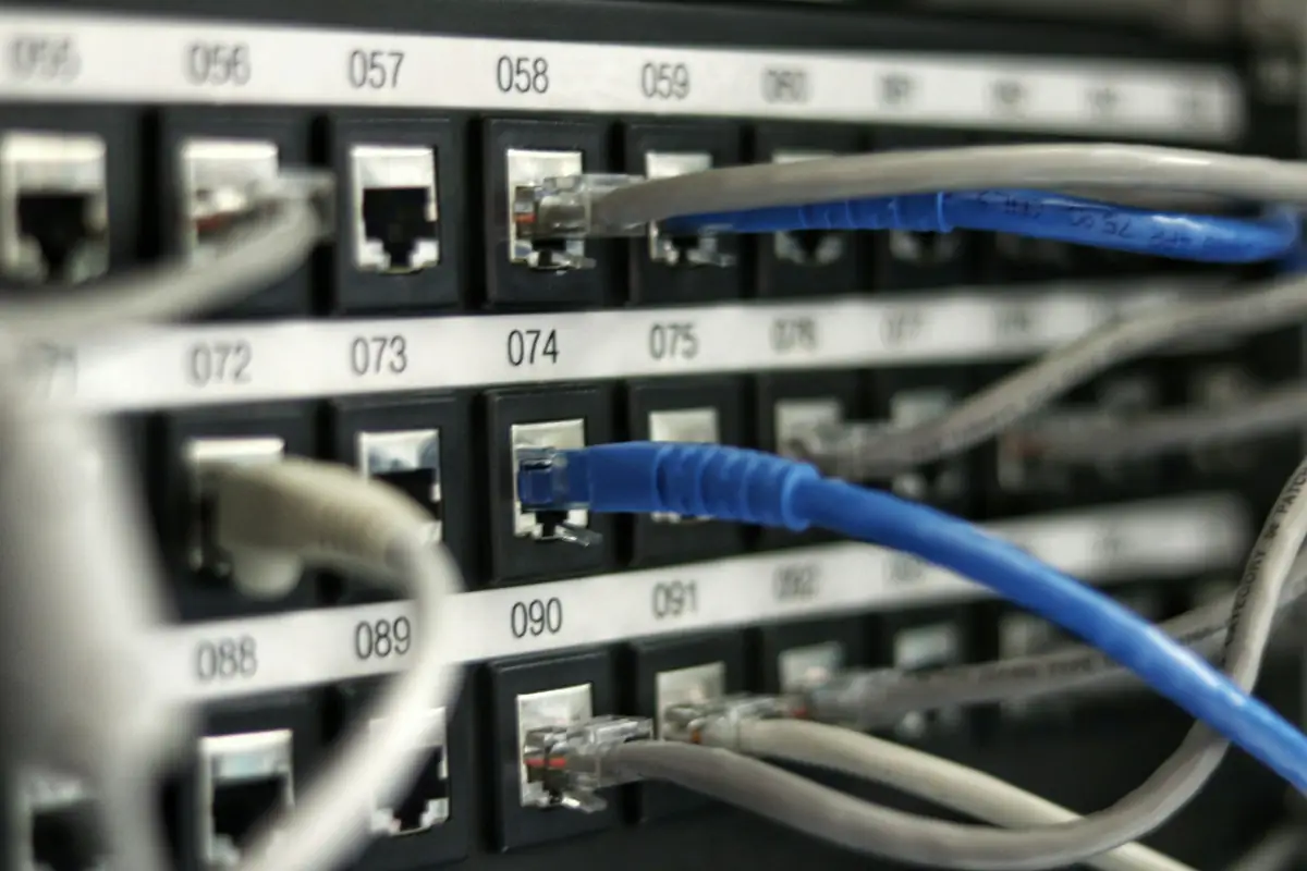 Close-up of a patch panel with numbered ports and connected network cables